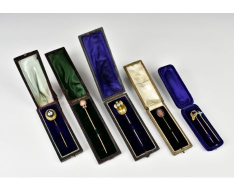 Six Victorian and Edwardian stick pins, including an 18ct gold pietra dura pin; an 18ct gold, coral and diamond lyre shaped p