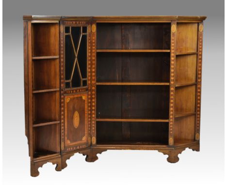 An Edwardian mahogany and satinwood cross banded glazed corner low bookcase, the satinwood cross banded and boxwood and ebony