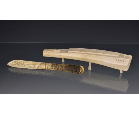 An Inuit carved walrus tusk cribbage board, early to mid-20th century, carved in relief with a seal and small dog to either e