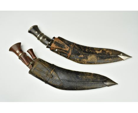 Two Kukri with leather scabbards and accompanying knives, probably late 19th / early 20th century, the first with horn handle