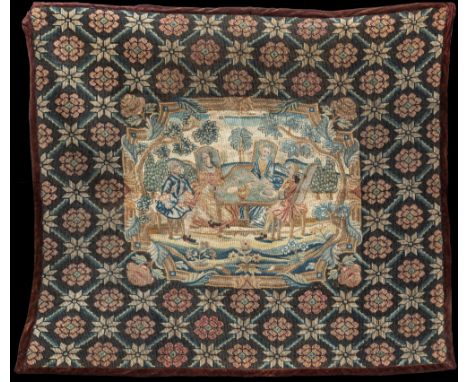 An early 18th century needlework panel, the central panel in fine needlepoint depicting two noblemen and their wives seated a