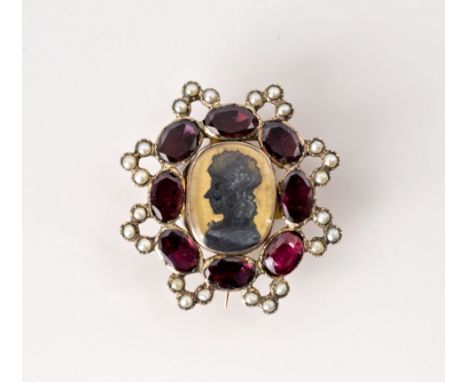 A 19th century yellow metal, garnet and seed pearl double portrait silhouette mourning brooch, with a small portrait silhouet