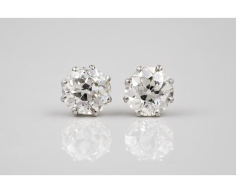 A good pair of solitaire diamonds in platinum settings, the pair of old, brilliant cut diamonds totalling approx. 2.5ct, of v