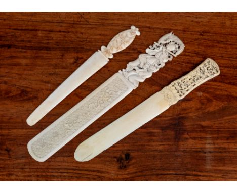 Three Chinese Canton carved ivory page turners, 19th century, one with blade carved with auspicious objects against a diaper 