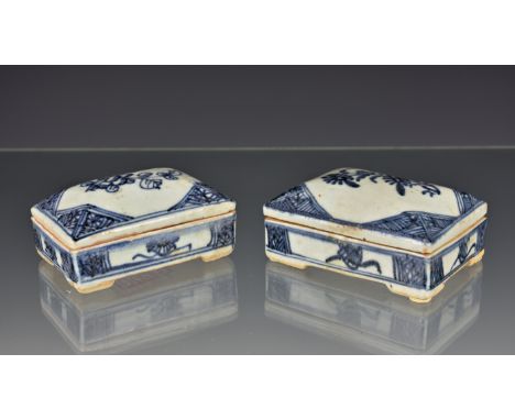 Two Chinese porcelain blue and white covered epitaph or funerary boxes, rectangular with domed covers, painted with a flower 