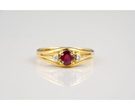 An 18ct yellow gold, ruby and diamond ring, the central oval cut ruby flanked by brilliant cut diamonds in heart shaped setti