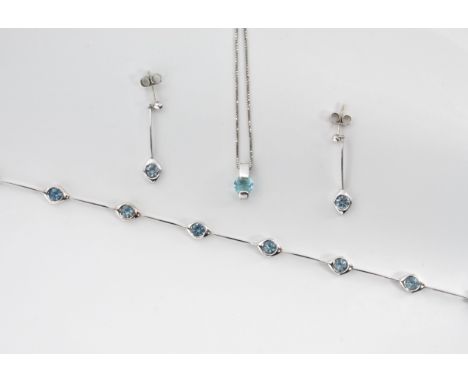 A suite of 9ct white gold and aquamarine jewellery, comprising a bracelet with six spectacle set round cut aquamarines, 6¾in.