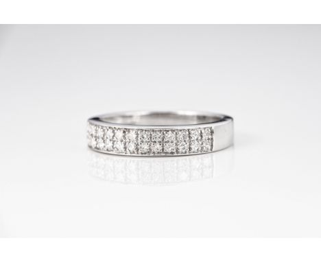 An 18ct white gold and diamond two row eternity ring, pavé set with two rows of princess cut diamonds, total 0.25ct, ring siz