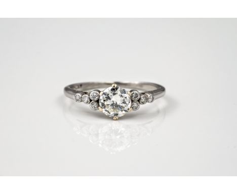 A vintage platinum and diamond ring, probably 1950s, the central 0.80ct brilliant cut diamond flanked either side by four sma