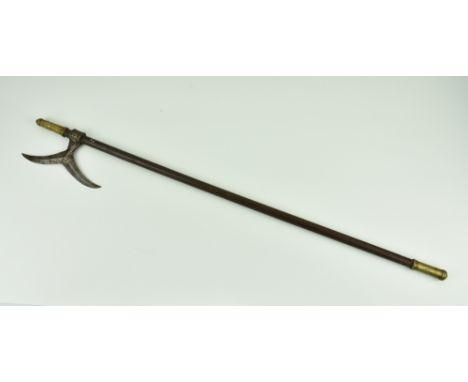 An Indo-Persian axe, probably 19th century, brass mounts and wooden shaft, 33in. (83.8cm.) long., *Condition:the axe head wit