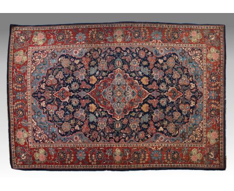 A Persian Saruk rug, second quarter 20th century, the single pale blue and madder pendant lozenge medallion on a dark blue fi