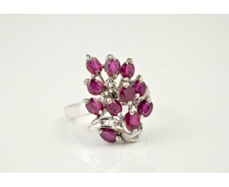 A 1950s-60s 18ct white gold, ruby and diamond floral design ring, Continental 18k hallmarks, designed as a spray of flowers s