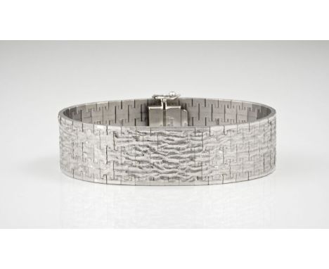 A vintage 9ct white gold bark effect strap bracelet, hallmarked Birmingham 1967, the 7 1/8in. (18.1cm.) long.