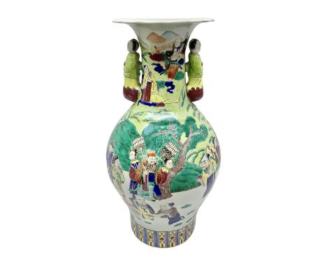 20th century Chinese Famille Rose vase, of baluster form with flared lobed rim and twin figural handles, decorated in polychr