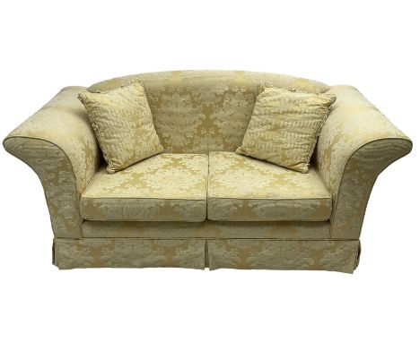 Two-seat hardwood framed sofa, traditional shape with arched cresting rail over rolled arms, upholstered in pale gold and cre