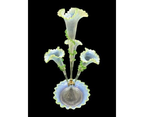 Victorian Vaseline glass epergne, the frilled circular bowl supporting a central frilled trumpet, flanked by three smaller tr