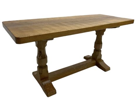 Mouseman - oak coffee table, adzed rectangular top on octagonal supports, on sledge feet united by floor stretcher, carved wi