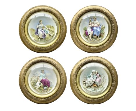 Set of four early 20th century Continental bisque plaques, each of circular form, modelled in high relief as the Four Seasons