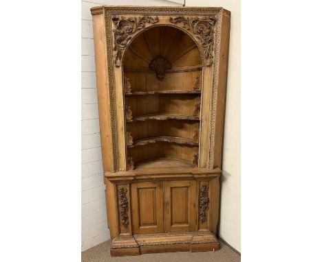 A Victorian carved pine corner cabinet with architectural doomed top and applied carved decoration (H210cm W120cm D60cm)