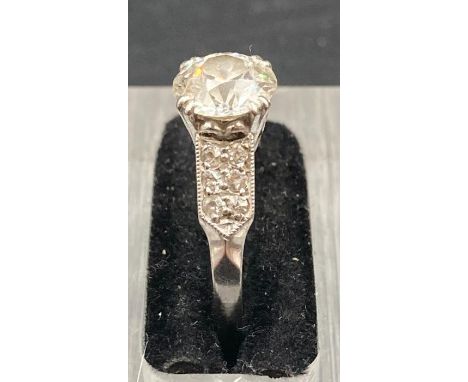 An Art Deco diamond ring, centre stone approx 1.35ct (Chip to stone) I/J colour SI1 clarity. Total weight of diamonds approx 