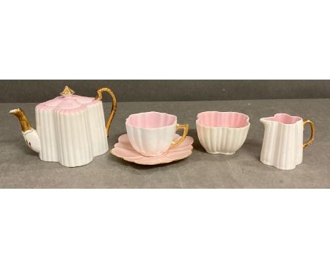 A Wileman and Co pink and white scalloped tea set to include cup and saucer, sugar bowl, tea pot and milk jug 