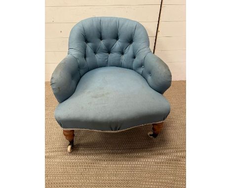 A salon button back chair on castors 