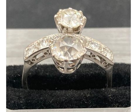 An Art Deco style double diamond ring, set in platinum. The main diamonds weigh approx 1ct and 0.75ct J/K colour and SI2 clar