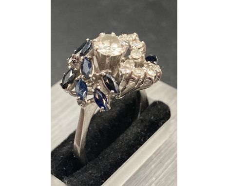 A sapphire and diamond cocktail ring set in 18ct white gold, Main diamond weighing approx 0.6cts I/J colour SI1 clarity (Size