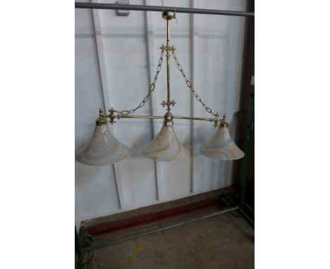 A brass billiard light, with associated glass swirl shades 