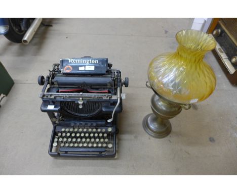 A Remington typewriter and a Victorian oil lamp 