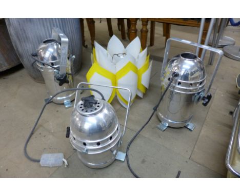 A 1960's style white and yellow lamp shade and three chrome stage lights 