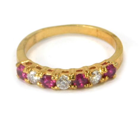 A dress ring, set with paste stones, on a gold plated band, ring size Q. 