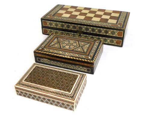 Three Middle Eastern inspired storage boxes, all with bone and mother of pearl inlaid design, including a games compendium bo