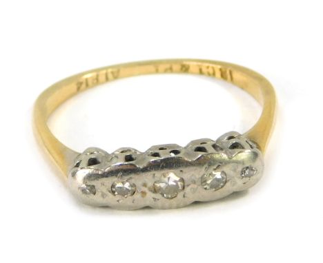 A Victorian 18ct gold platinum and diamond dress ring, the platinum bar set with five tiny diamonds in an illusion setting, y