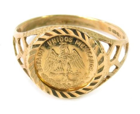 A 9ct gold coin ring, the central panel set with a Mexican Estados Unidos Emperados peso, in rope twist border with pierced d