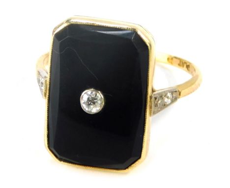 A Victorian octagonal onyx and diamond dress ring, with polished oval onyx in a yellow gold rub over setting, with central ti