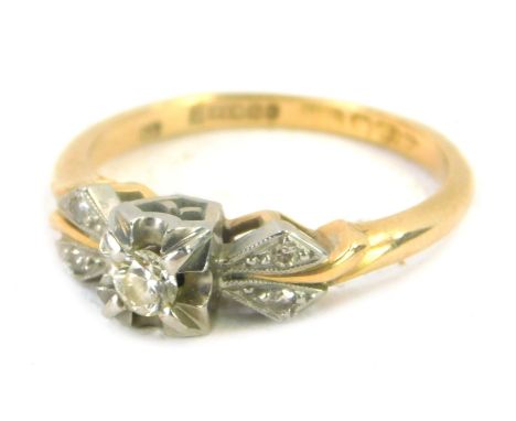 An 18ct gold diamond dress ring, the central stone approx 0.08ct, in four claw platinum setting, with tiny diamond set should