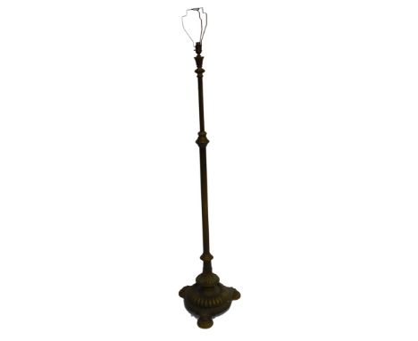 A Victorian brass standard lamp, with a fluted column, raised on a fluted triform base, raised on disc feet, 171cm high.