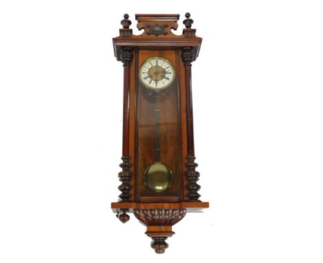 A late 19thC mahogany and walnut cased Vienna wall clock, circular brass dial with enamel chapter ring bearing Roman numerals
