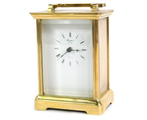 A Rapport of London brass cased carriage clock, with white enamel Roman numeric dial, and swing handle, 12cm high, 10cm wide,