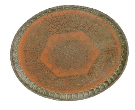 A Middle Eastern copper tray, embossed and engraved with hunting figures, within similar borders, together with script, 76cm 