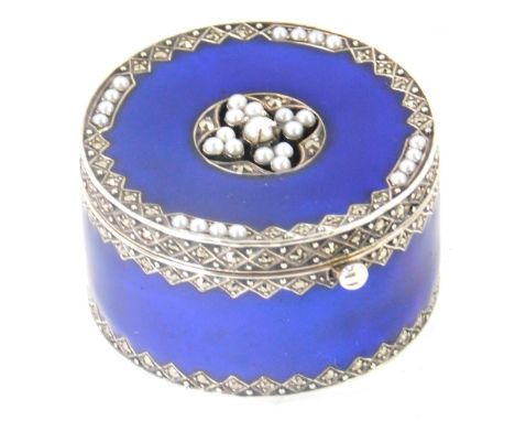 A silver and enamel pill box, with a cultured pearl set top with marcasite, with blue enamel backing, 3.5cm diameter, 1.51oz.