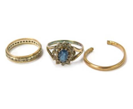 Three dress rings, comprising a silver floral cluster ring, a 9ct gold band, cut, and a 9ct gold and silver diamond eternity 