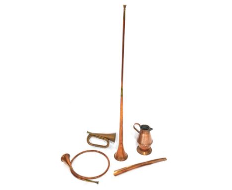 Copper wares, comprising a copper coaching horn, bugle, French horn, jug and a shoe horn. (5)