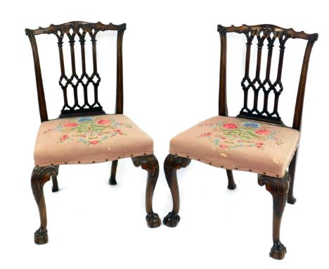 A pair of Gothic Chippendale design chairs, with carved backs, serpentine seats, and cabriole legs with ball and claw feet, 5