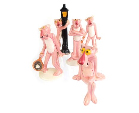 A group of four Japanese ceramic United Artists Pink Panther figures, two playing tennis, one standing beside a lamp post, th