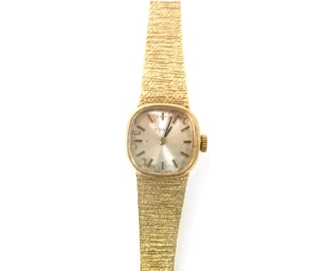 A Tissot 9ct gold cased lady's wristwatch, with a silvered watch head on a bark effect bracelet, 17cm long, 25.8g all in. 
