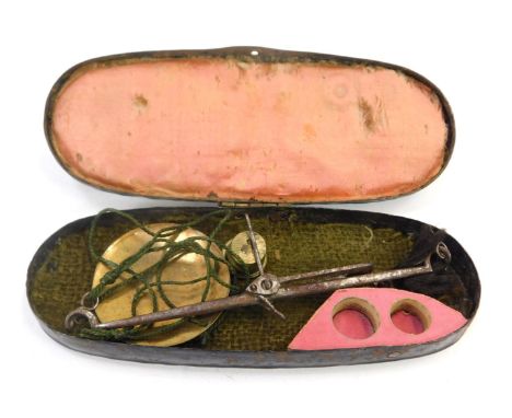 A pair of miniature sovereign scales, in tin carry case. 