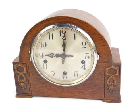 A 1950s Enfield oak cased mantel clock, with a silvered numeric dial, eight day movement with Westminster chimes, the domed c
