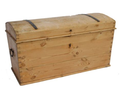 A Victorian domed pine and iron bound trunk, with cast iron carrying handles, 54cm high, 103cm wide, 53cm deep.